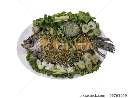 Delicious deep fried fish giant gourami and Herb salad topping with crispy fried garlic. 96765939