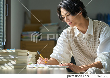 Young man studying by the window 96767122