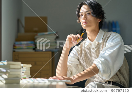 Young man studying by the window 96767130