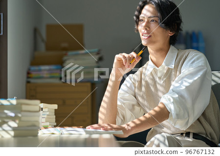 Young man studying by the window 96767132