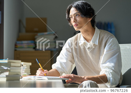 Young man studying by the window 96767226