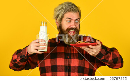 Lucky in Love Classic Milk and Cookies. Fresh healthy milk. glass of milk with cookies for santa claus on christmas eve. happy farmer eat biscuit. bearded man drink useful milk with pastry Lucky in Love Classic Milk and Cookies. Fresh healthy milk. glass of milk with cookies for santa claus on christmas eve. happy farmer eat biscuit. bearded man drink useful milk with pastry 96767255