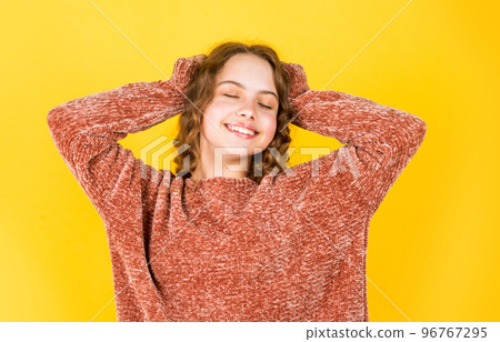 Enjoy silky hair. Beautiful little model. Healthy curls. Easy hairdo. Beauty supplies. Perfectly untangle curly hair. Pretty girl curly hair yellow background. Hairdresser salon. Adorable small child Enjoy silky hair. Beautiful little model. Healthy curls. Easy hairdo. Beauty supplies. Perfectly untangle curly hair. Pretty girl curly hair yellow background. Hairdresser salon. Adorable small child 96767295