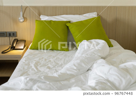 Messy bed sheets and pillow in the morning at bedroom Messy bed sheets and pillow in the morning at bedroom 96767448