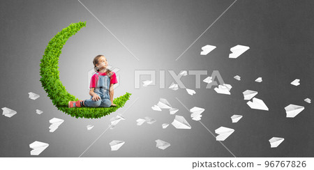 Concept of careless happy childhood with girl on green moon Concept of careless happy childhood with girl on green moon 96767826