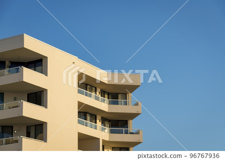 Building exterior with balconies at the corners against the blue sky in Destin, Florida Building exterior with balconies at the corners against the blue sky in Destin, Florida 96767936