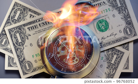 Burning pocket watch with dollar banknotes 96768052