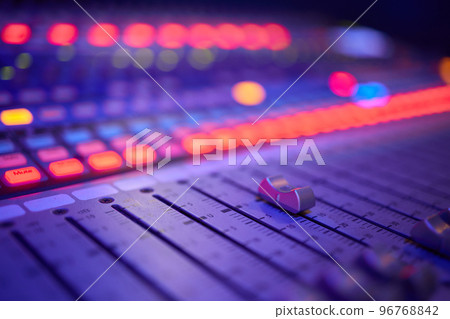 View of music mixer in concert, filled with lights. 96768842