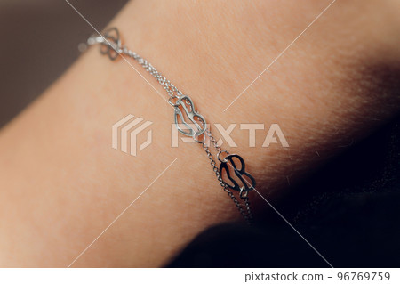 Close up Detail of a Bracelet on a Female Hand Model - Image of a beautiful sparkling fashion accessory bracelet. Close up Detail of a Bracelet on a Female Hand Model - Image of a beautiful sparkling fashion accessory bracelet. 96769759