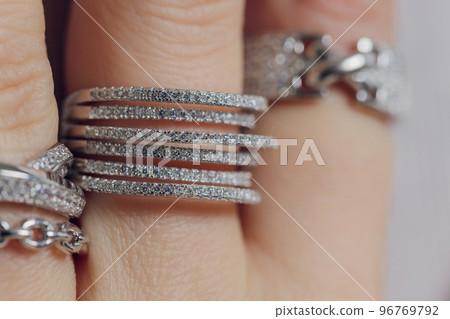 close up of boho styled woman hands with silver jewelry. close up of boho styled woman hands with silver jewelry. 96769792