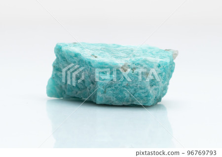 Natural amazonite gemstone isolated on white background. A bluish-green crystal on a white background. A variety of potassium feldspar microcline 96769793