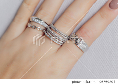 close up of boho styled woman hands with silver jewelry. close up of boho styled woman hands with silver jewelry. 96769801
