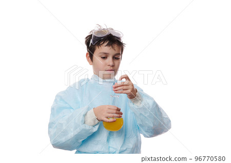 Smart teenage schoolboy in protective laboratory coat, conducts a scientific experiment in a chemistry lesson, using a glass rod, mixes reagents with chemicals in lab flask, isolated on white backdrop Smart teenage schoolboy in protective laboratory coat, conducts a scientific experiment in a chemistry lesson, using a glass rod, mixes reagents with chemicals in lab flask, isolated on white backdrop 96770580
