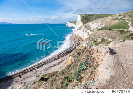Beach sea and cliffs view in Durdle door in Lulworth, Dorset, United Kingdom. Part of Jurassic Coast World Heritage Site, selective focus Beach sea and cliffs view in Durdle door in Lulworth, Dorset, United Kingdom. Part of Jurassic Coast World Heritage Site, selective focus 96770789