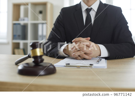 Professional lawyer who provides legal consultations at office desk with judge's gavel 96771142
