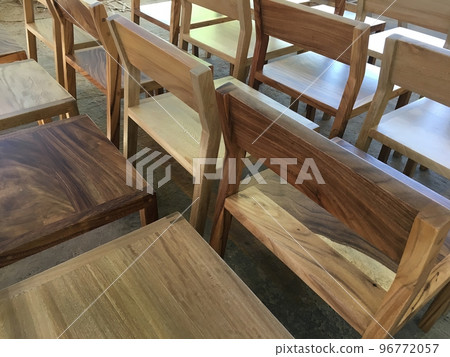 A chair modern wood frame with wooden, sunlight coming through the window illuminating the chair A chair modern wood frame with wooden, sunlight coming through the window illuminating the chair 96772057