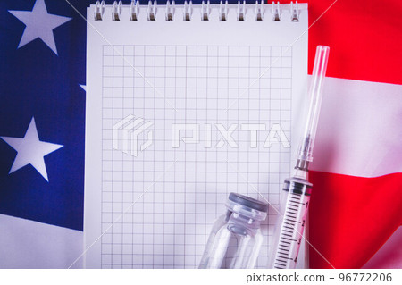 Syringe and vaccine on background of american flag. Vaccination in sasha. Blank notepad for vaccination records. 96772206
