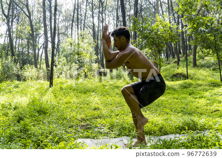 man seen up close, without shirt doing stretches on yoga mat, exercise, latin america man seen up close, without shirt doing stretches on yoga mat, exercise, latin america 96772639