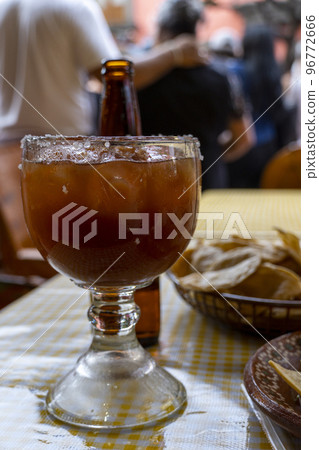 A view of a michelada beverage among a variety of Mexican A view of a michelada beverage among a variety of Mexican 96772666