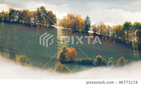 Landscape of foggy valley in an autumn morning. Landscape of foggy valley in an autumn morning. 96773219