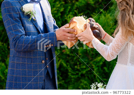 Ukrainian wedding tradition is to dip bread in honey and eat it. Ukrainian wedding tradition is to dip bread in honey and eat it. 96773322