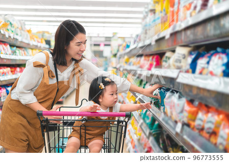 Asian mother and her daughter buying food at huge supermarket , Baby sit in trolley, Family shopping concept. 96773555
