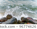 The waves of the sea crash on the rocks. Big rocks on the shore. Stony seashore. 96774626