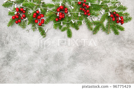 Christmas tree branches red berries silver garland decoration Christmas tree branches red berries silver garland decoration 96775429