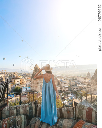 Young woman in dress on the roof with amazing view of Cappadocia in Turkey 96776662