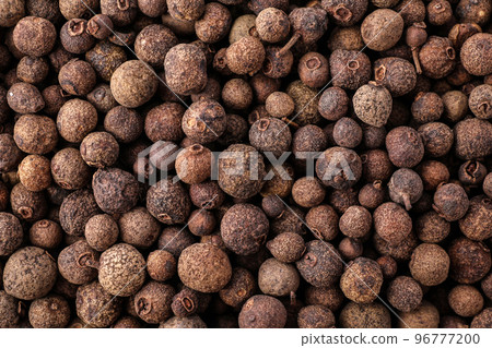 Black pepper grains as background, top view 96777200