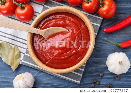 Flat lay composition with tomato sauce on blue wooden background Flat lay composition with tomato sauce on blue wooden background 96777257