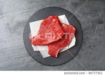 Fresh raw beef cut on grey table, top view Fresh raw beef cut on grey table, top view 96777361