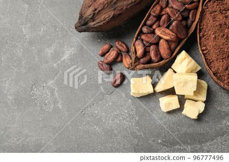 Flat lay composition with organic cocoa butter on grey table. Space for text 96777496
