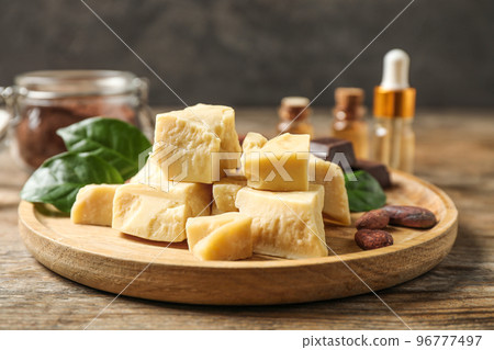 Composition with organic cocoa butter on wooden table 96777497