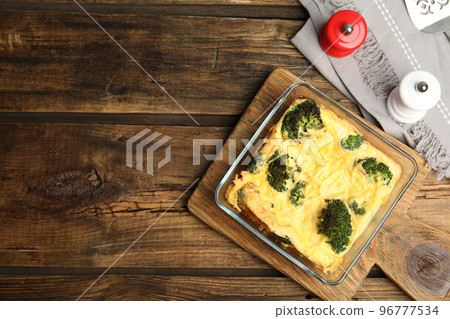 Tasty broccoli casserole in baking dish on wooden table, flat lay. Space for text Tasty broccoli casserole in baking dish on wooden table, flat lay. Space for text 96777534