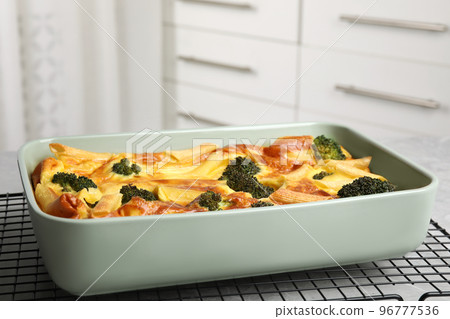 Tasty broccoli casserole in baking dish on cooling rack Tasty broccoli casserole in baking dish on cooling rack 96777536