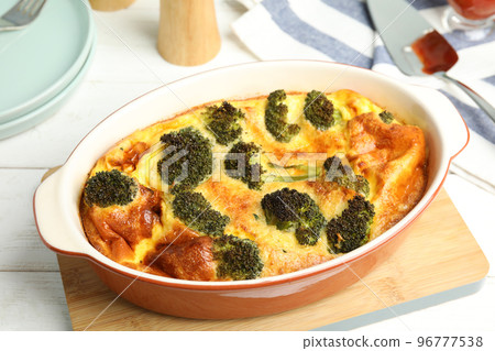 Tasty broccoli casserole in baking dish on white wooden table 96777538