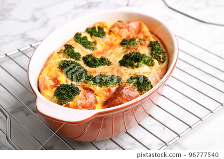 Tasty broccoli casserole in baking dish on cooling rack, closeup Tasty broccoli casserole in baking dish on cooling rack, closeup 96777540