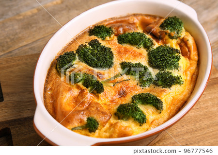 Tasty broccoli casserole in baking dish on wooden board, closeup Tasty broccoli casserole in baking dish on wooden board, closeup 96777546