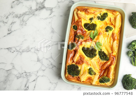 Tasty broccoli casserole in baking dish on white marble table, flat lay. Space for text Tasty broccoli casserole in baking dish on white marble table, flat lay. Space for text 96777548