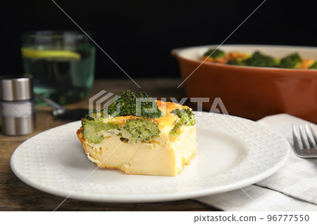 Tasty broccoli casserole served on wooden table, closeup Tasty broccoli casserole served on wooden table, closeup 96777550