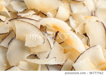 Delicious fresh coconut chips as background, closeup Delicious fresh coconut chips as background, closeup 96777562