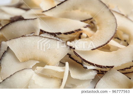 Delicious fresh coconut chips as background, closeup Delicious fresh coconut chips as background, closeup 96777563