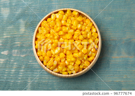 Tasty canned sweet corn on blue wooden table, top view Tasty canned sweet corn on blue wooden table, top view 96777674