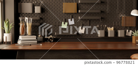 Modern black home office space with accessories and copy space on wood table against the black wall 96778821