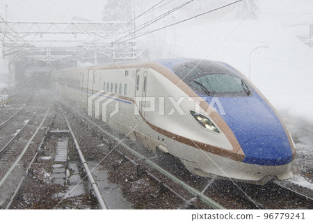 Joetsu Shinkansen E7 series going through Niigata Prefecture in a snowstorm 96779241