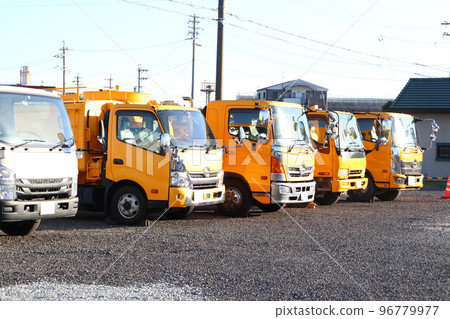 High-pressure cleaning vehicles and trucks are parked in a row 96779977