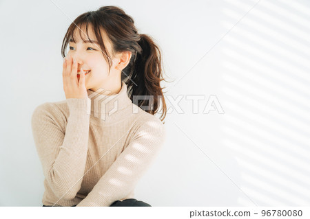 Smiling woman wearing turtleneck knit Smiling woman wearing turtleneck knit 96780080