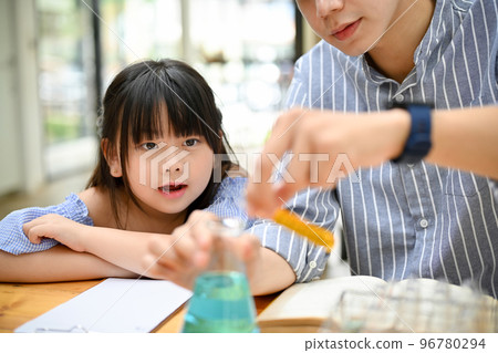 Cute young Asian girl is excited and enjoying doing a science experiment with her teacher Cute young Asian girl is excited and enjoying doing a science experiment with her teacher 96780294