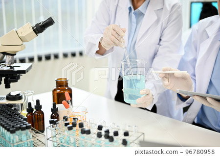 Two expert female scientist working together in the laboratory. cropped image 96780958
